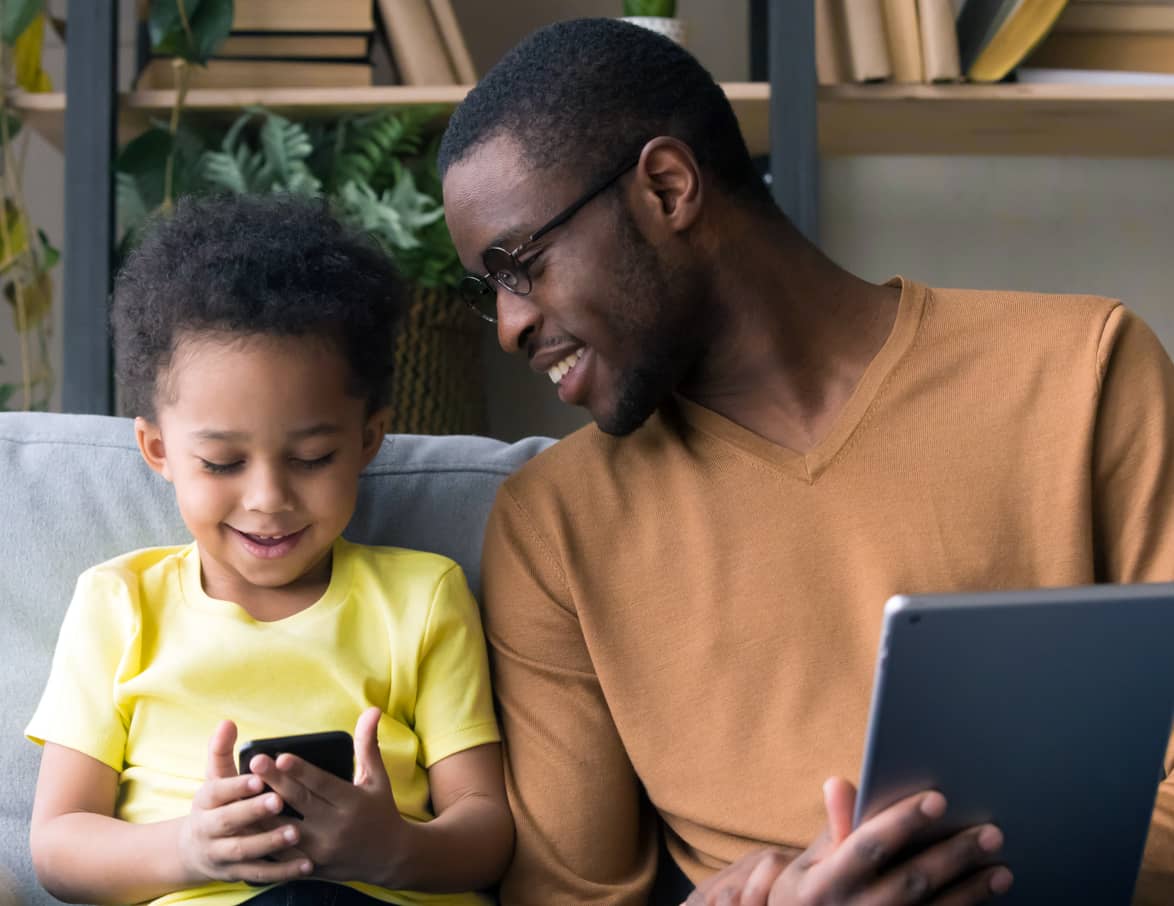 Father and child a tablet and phone together