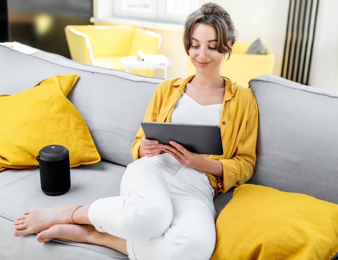 Woman using tablet on sofa